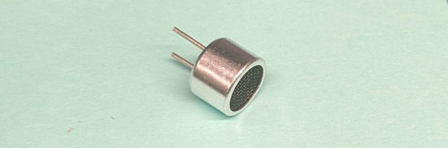 A photograph showing a small transducer in a metal can