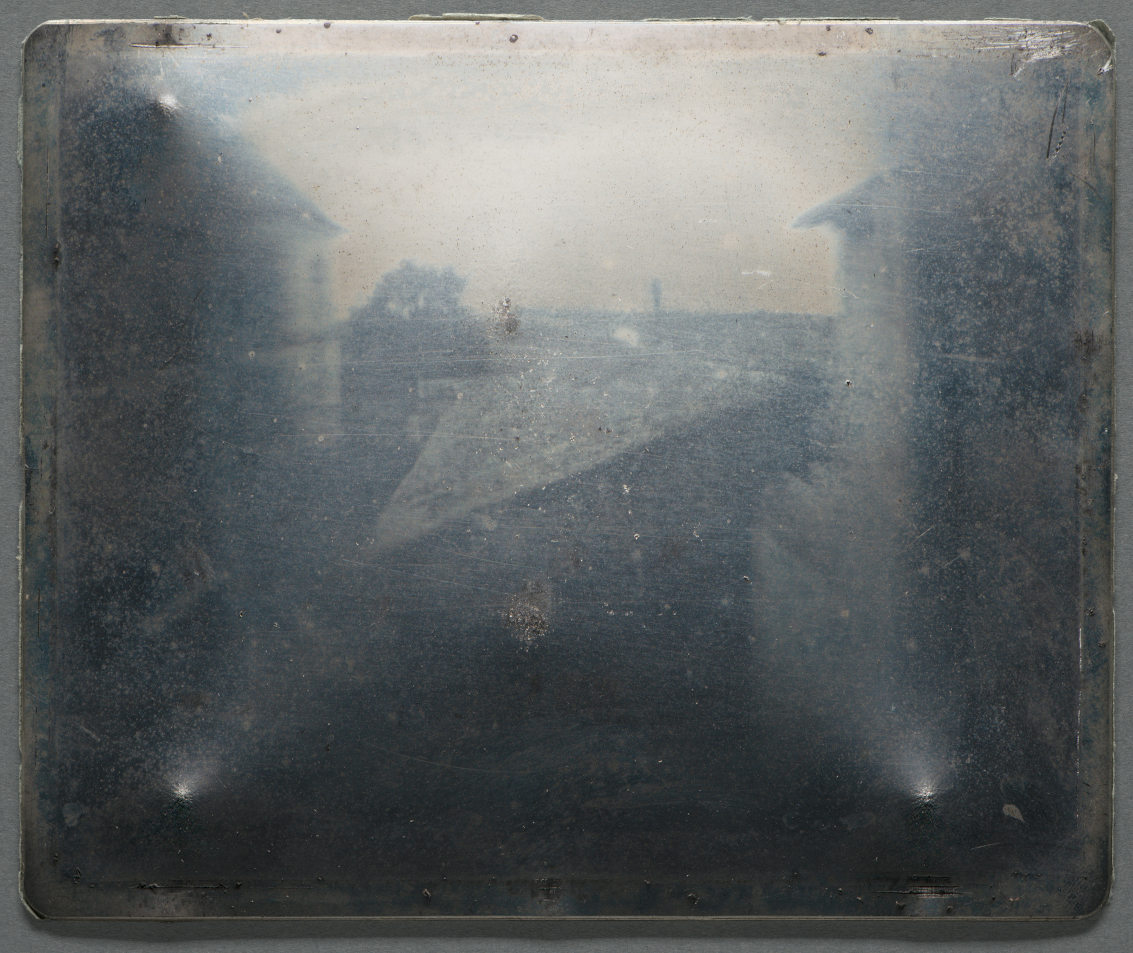 A ghostly image of rooftops, recorded on a metal plate.